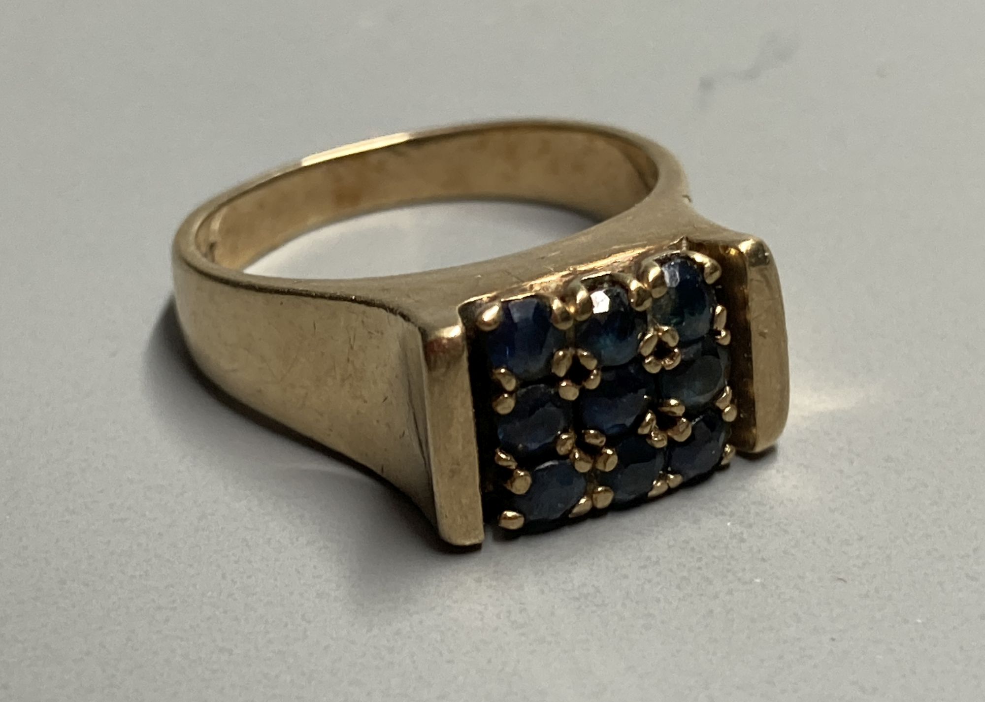 A mid to late 20th century 9ct and nine stone sapphire square cluster ring, size L, gross 5.6 grams.